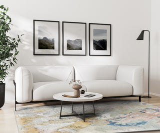 Exquisite Rugs Floor Art 6315 in modern living room with a white sofa, coffee table, and framed mountain pictures on the wall featured image.